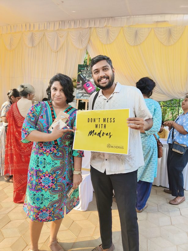 Visitors holding the Don't Mess With Madras placard